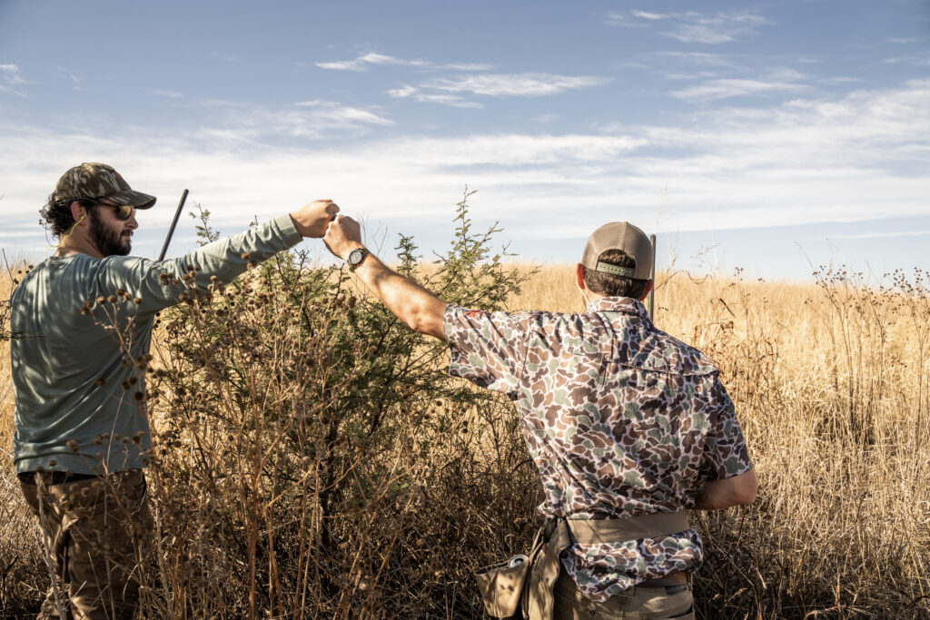 Hunter and bird boy celebrating a successful dove hunt in Córdoba, Argentina.